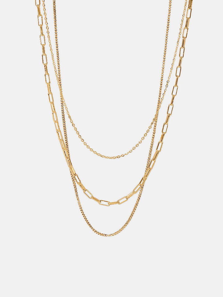 a gold chain necklace on a white background
