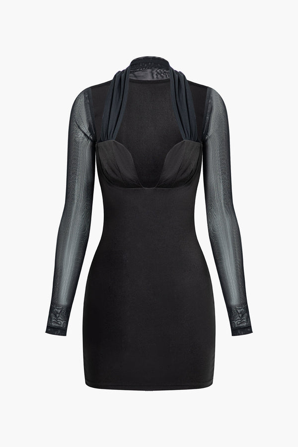 a woman wearing a black dress with sheer sleeves