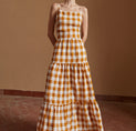 a woman in a yellow and white checkered dress