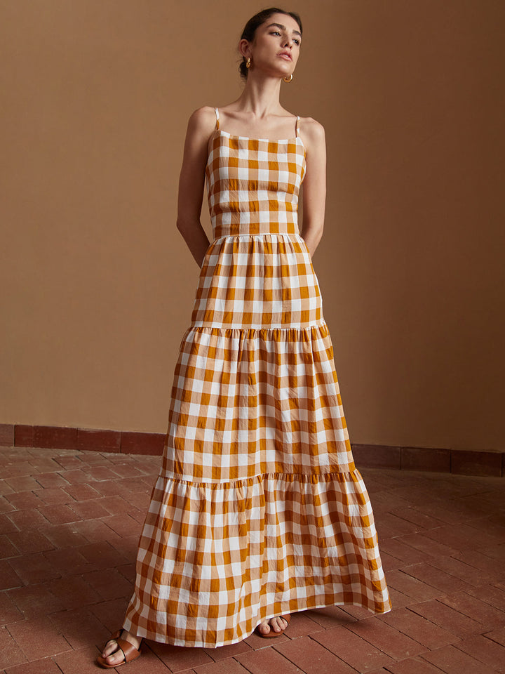 a woman in a yellow and white checkered dress