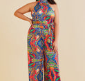 a woman wearing a multi colored jumpsuit