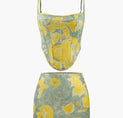 a crop top with a yellow and green floral print on it