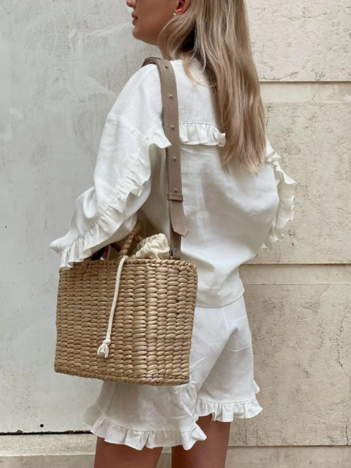 a woman wearing a white shirt and shorts with a basket bag
