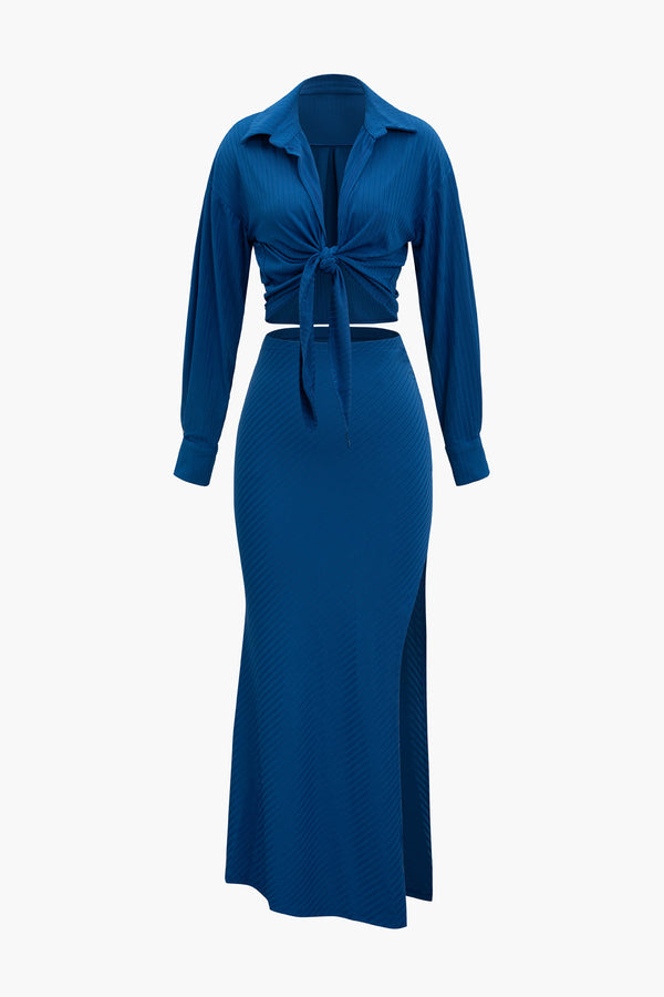 a woman wearing a blue dress with a tie around the waist