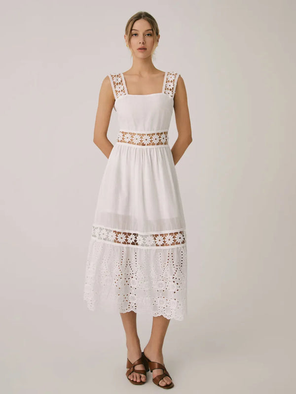 a woman wearing a white dress and sandals