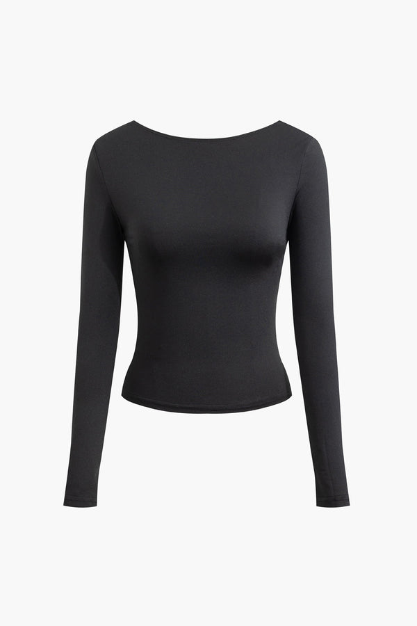 a woman wearing a black top with long sleeves