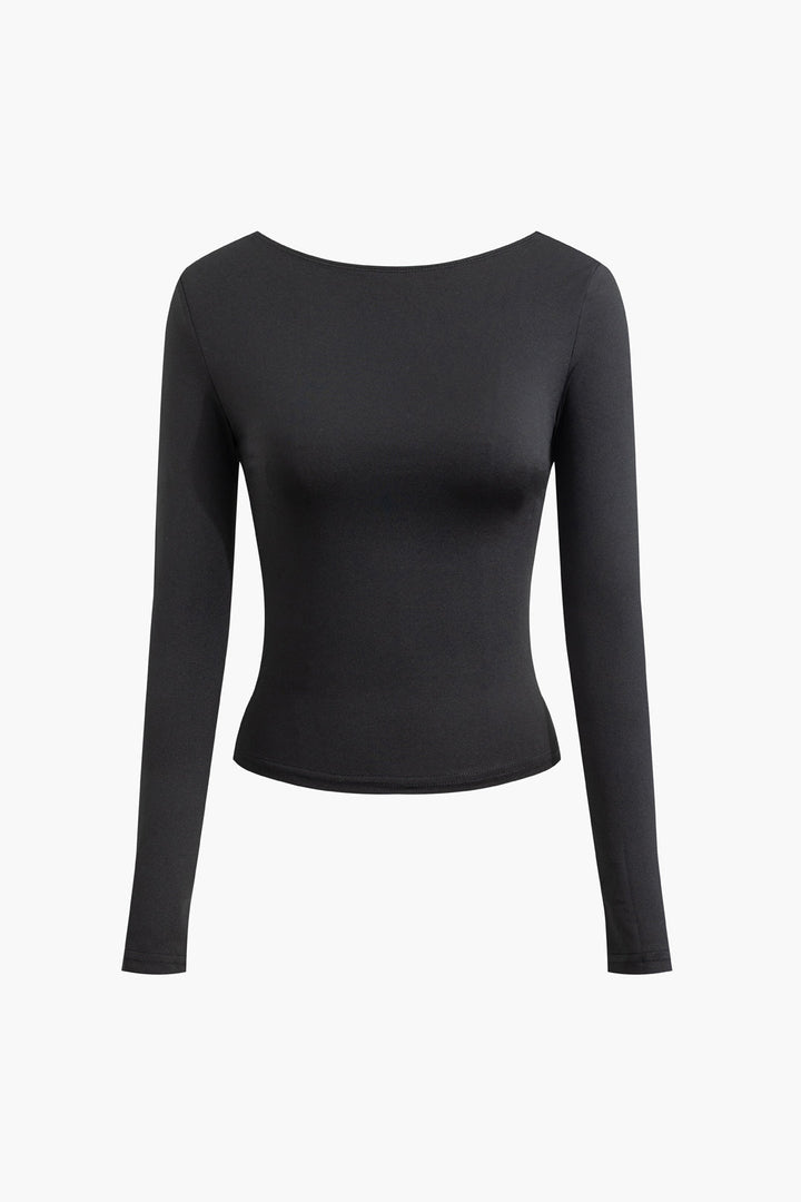 a woman wearing a black top with long sleeves