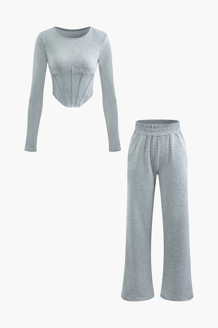 a woman wearing a grey top and pants