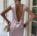 the back of a woman in a pink dress