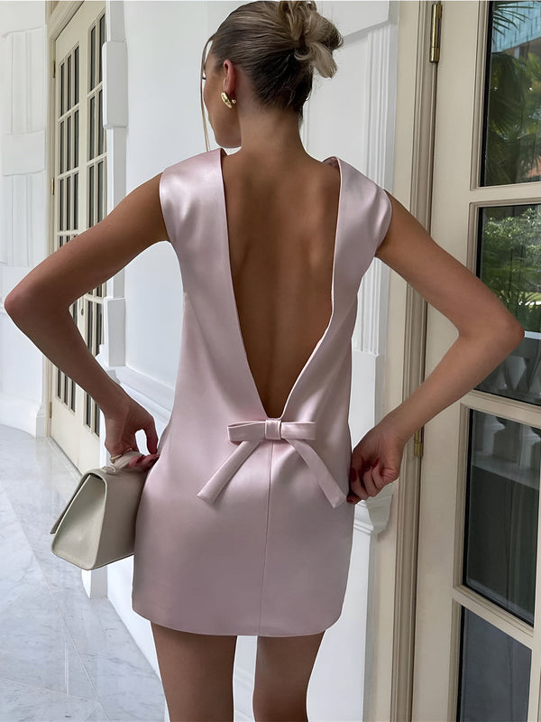 the back of a woman in a pink dress