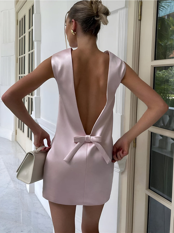 the back of a woman in a pink dress