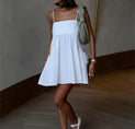 a woman wearing a white dress and white shoes