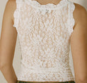 a woman wearing a white top and jeans