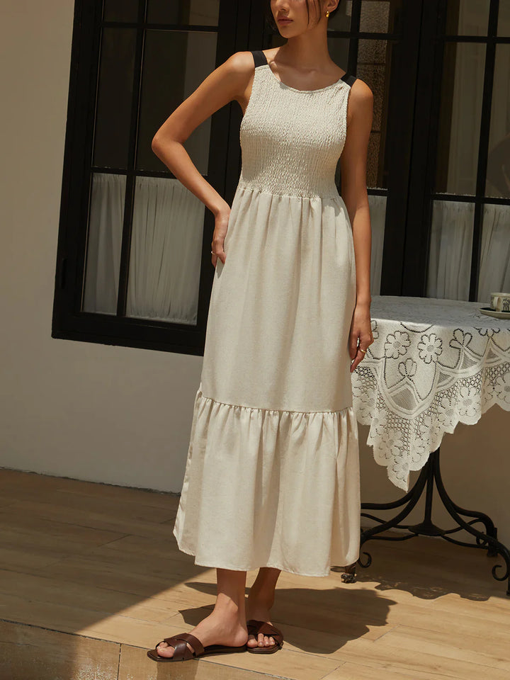 a woman in a white dress standing on a wooden floor