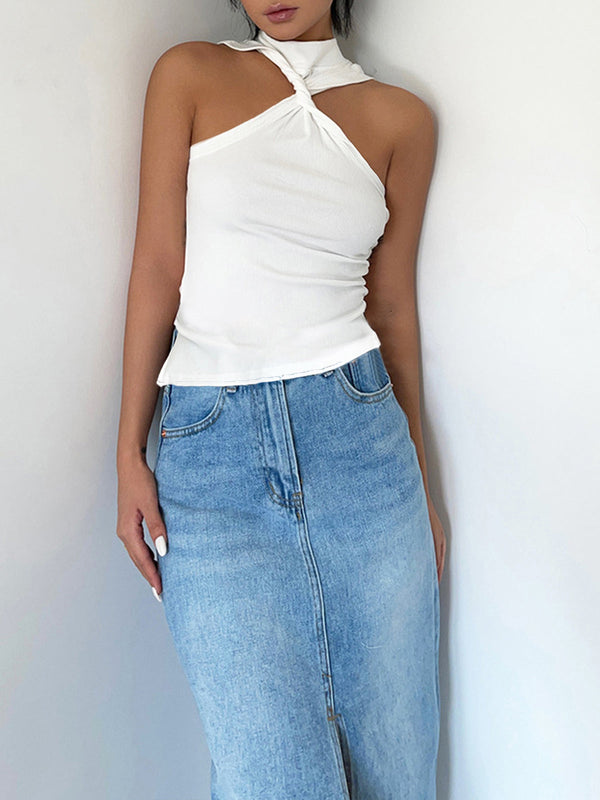 a woman wearing a white top and blue jeans