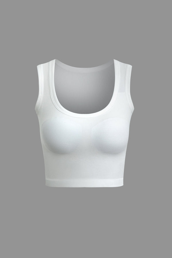 a woman ' s white sports bra top