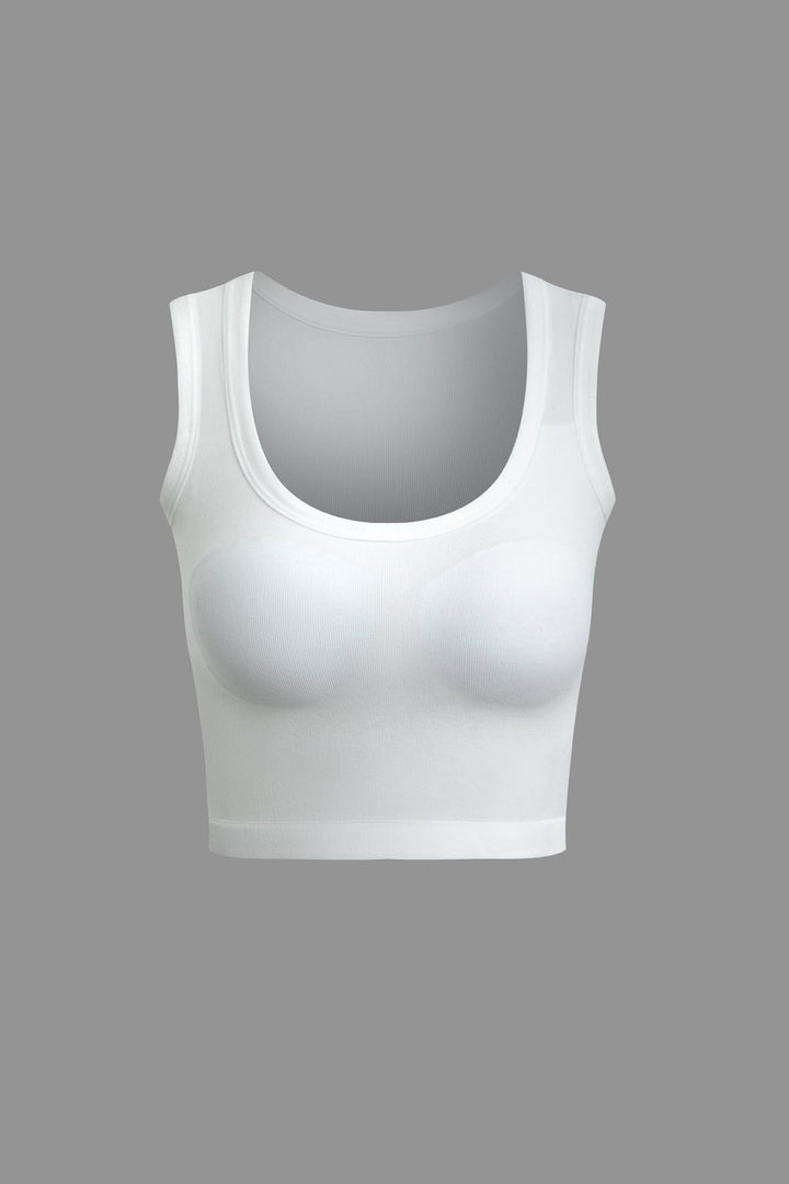 a woman ' s white sports bra top