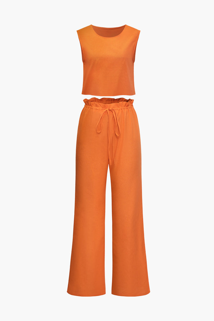 a woman is wearing an orange top and pants