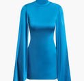 a woman wearing a blue turtle neck top