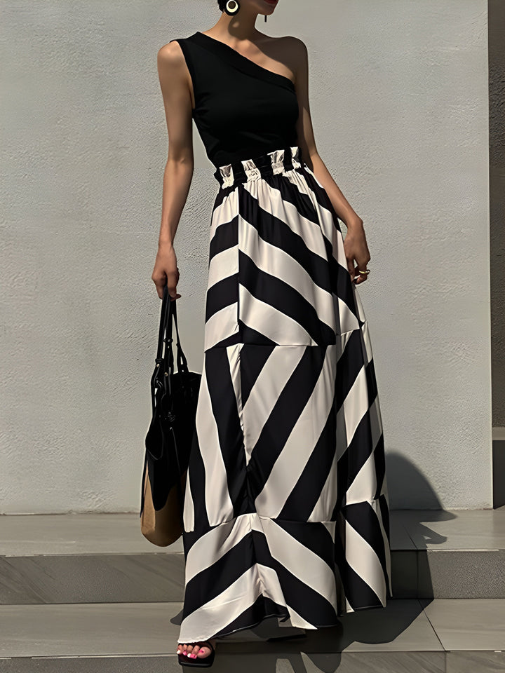 the woman is wearing a black and white dress