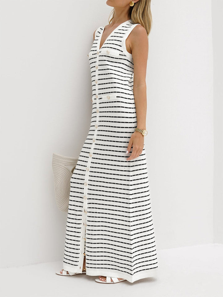 a woman wearing a white and black striped maxi dress