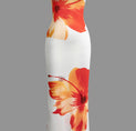 a white dress with orange flowers on it