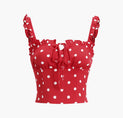 a red top with white polka dots on it