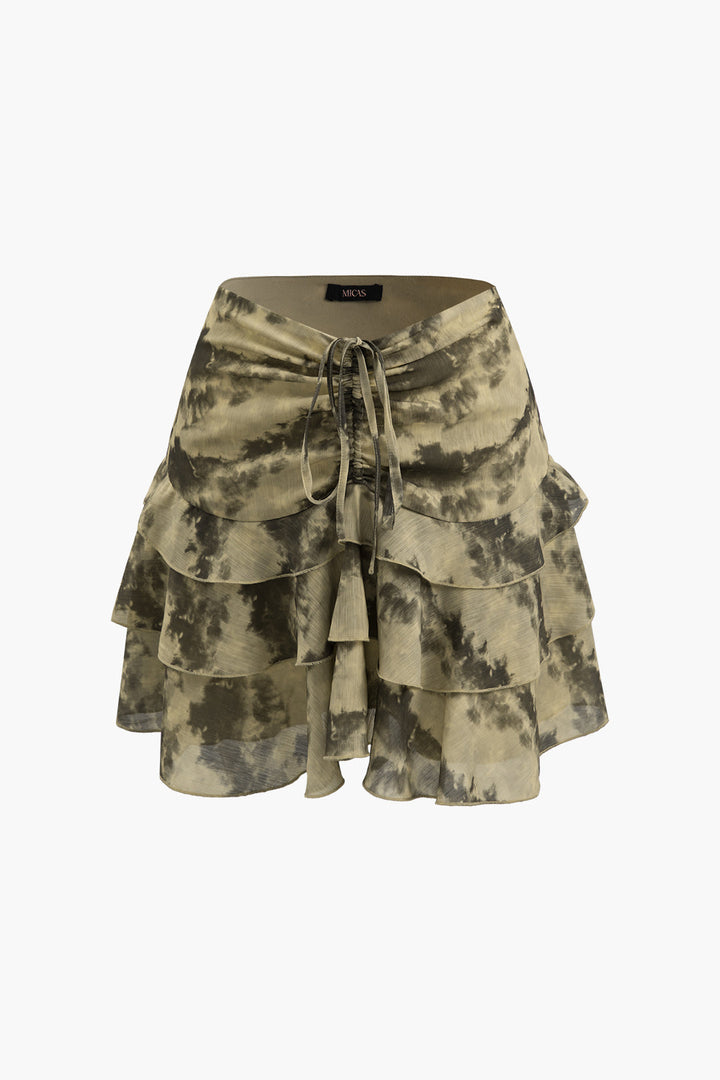 a woman wearing a black and white tie dye skirt