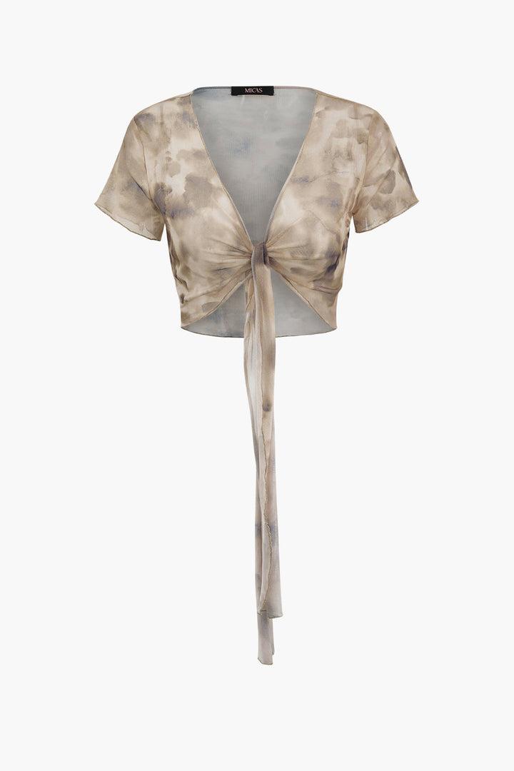 a top with a tie around the neck