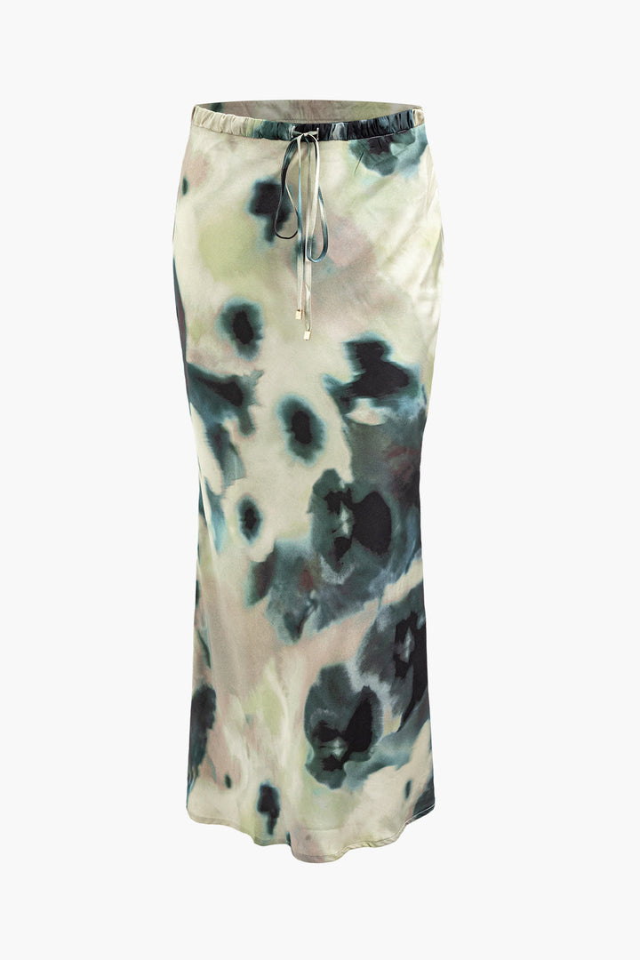 a white and black skirt with a tie around the waist