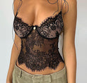 a woman wearing a black lace bra top