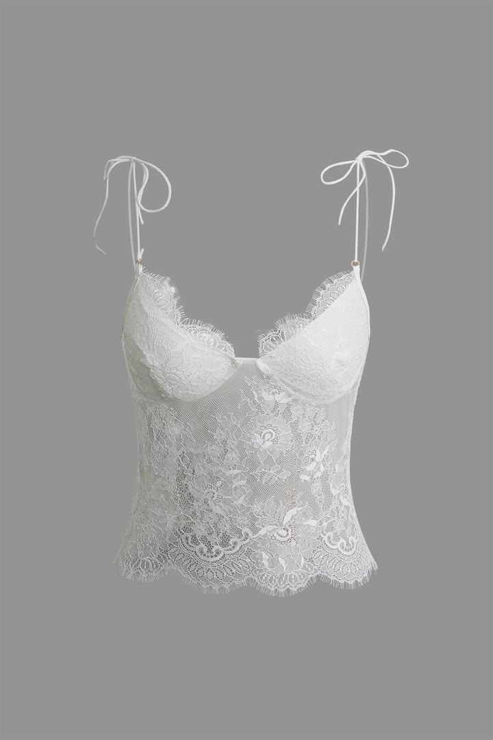 a white bra top with lace detailing on a grey background