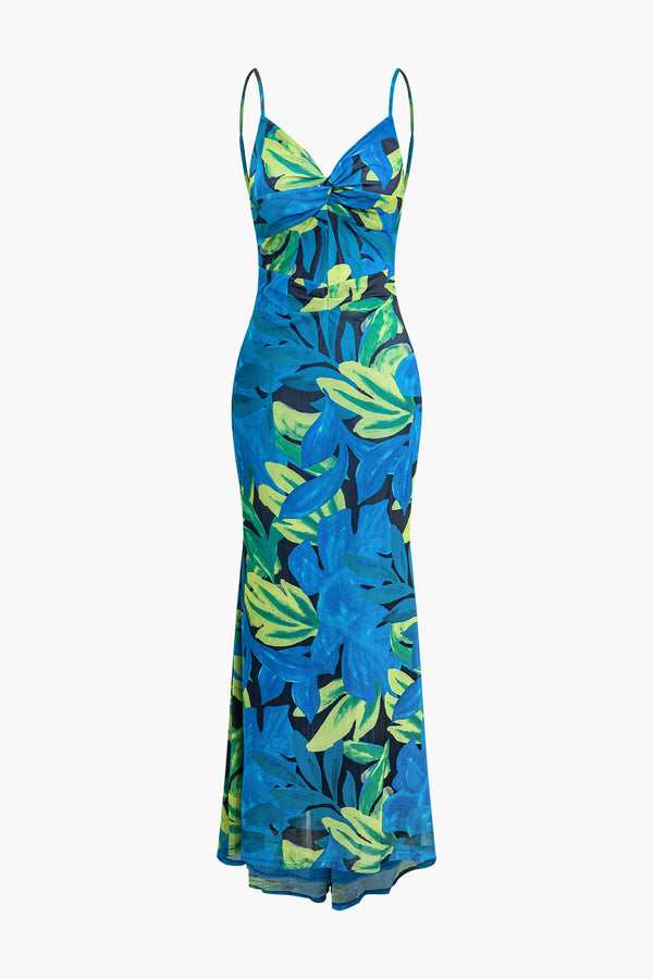 a blue dress with green leaves on it