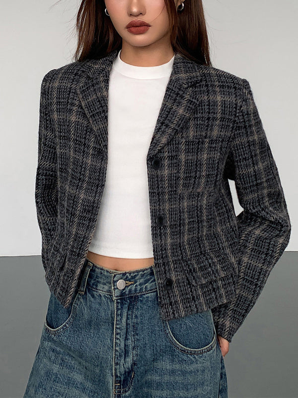 a woman wearing a black and white plaid jacket