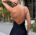 the back of a woman wearing a black dress