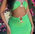 a woman in a green dress posing for the camera