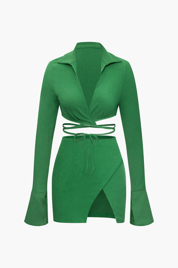 a green cardigan sweater with a tie around the neck