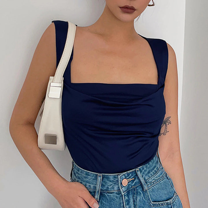 a woman wearing a blue top and denim shorts