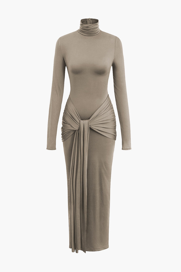 a woman in a beige dress with a long sleeve